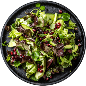 lettuce-salad-with-pomegranate-on-black-plate-top-2022-02-02-03-55-51-utc_isolated
