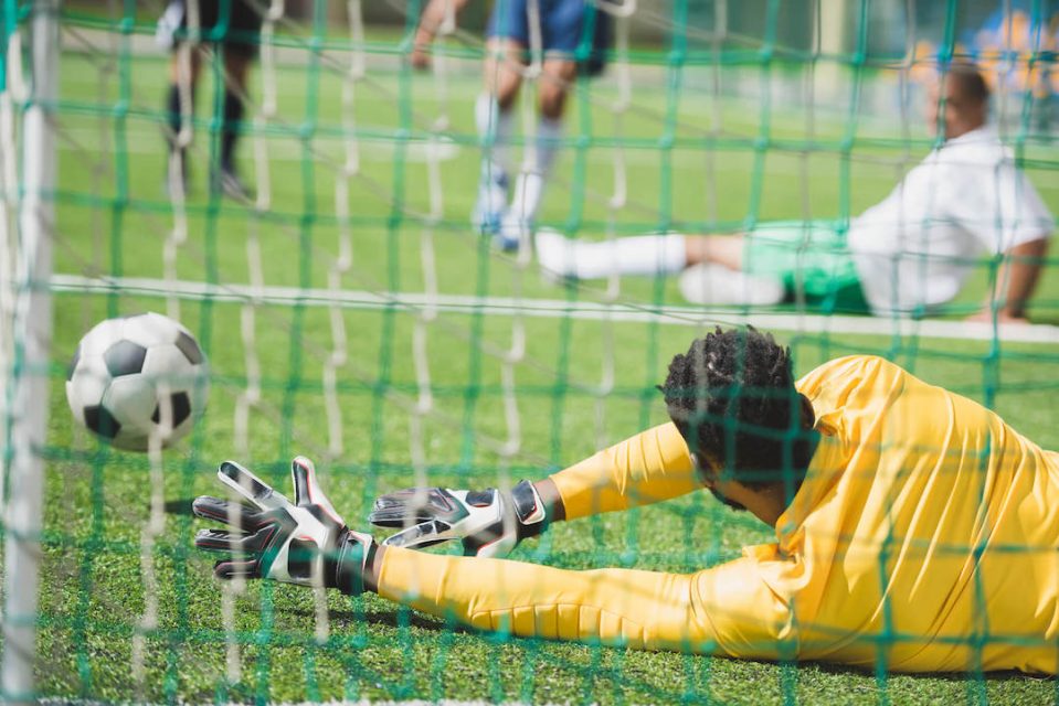 back-view-of-goalkeeper-catching-ball-during-socce-2021-08-29-11-18-39-utc