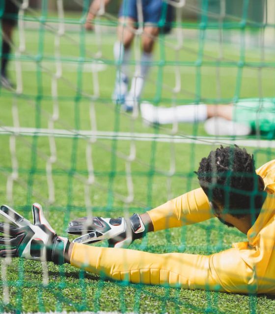 back-view-of-goalkeeper-catching-ball-during-socce-2021-08-29-11-18-39-utc