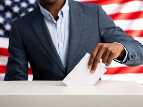 african-american-man-holds-envelope-in-hand-above-2022-12-16-07-55-47-utc