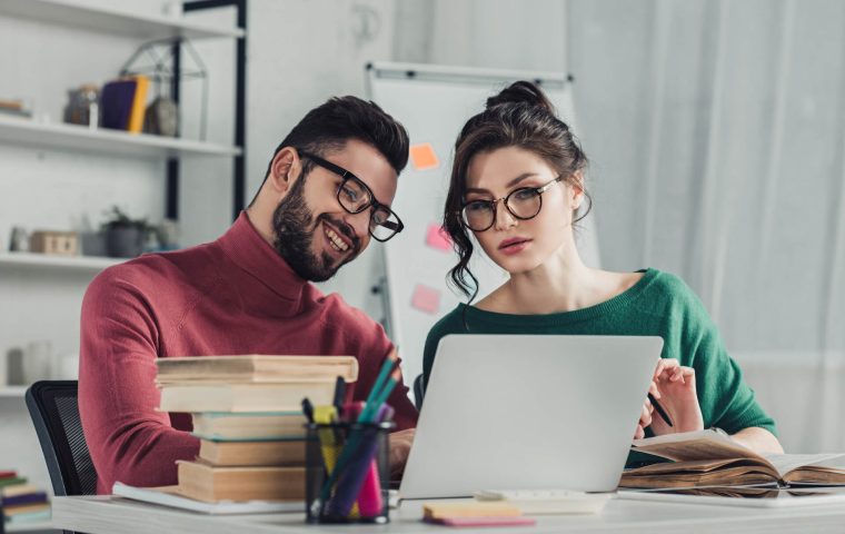cheerful-man-in-glasses-sitting-near-female-collea-2022-02-06-04-53-29-utc