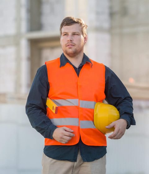 a-young-man-in-a-shirt-and-an-orange-vest-is-stand-2022-09-16-00-07-17-utc