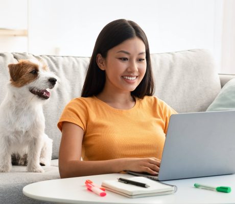 joyful-asian-lady-surfing-on-internet-cute-puppy-2022-12-16-08-55-57-utc