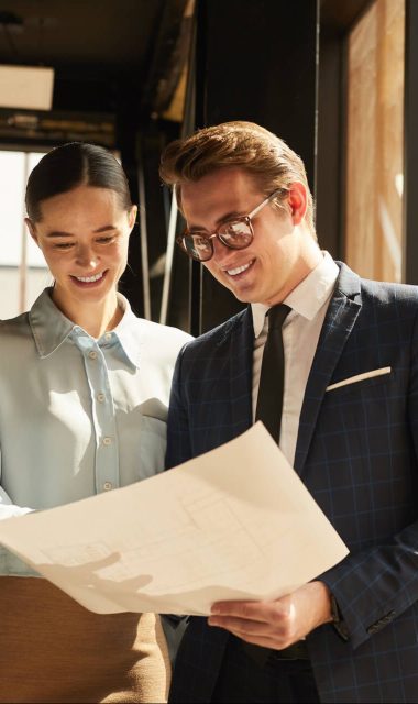 real-estate-agent-showing-plans-to-client-2021-09-24-04-09-39-utc